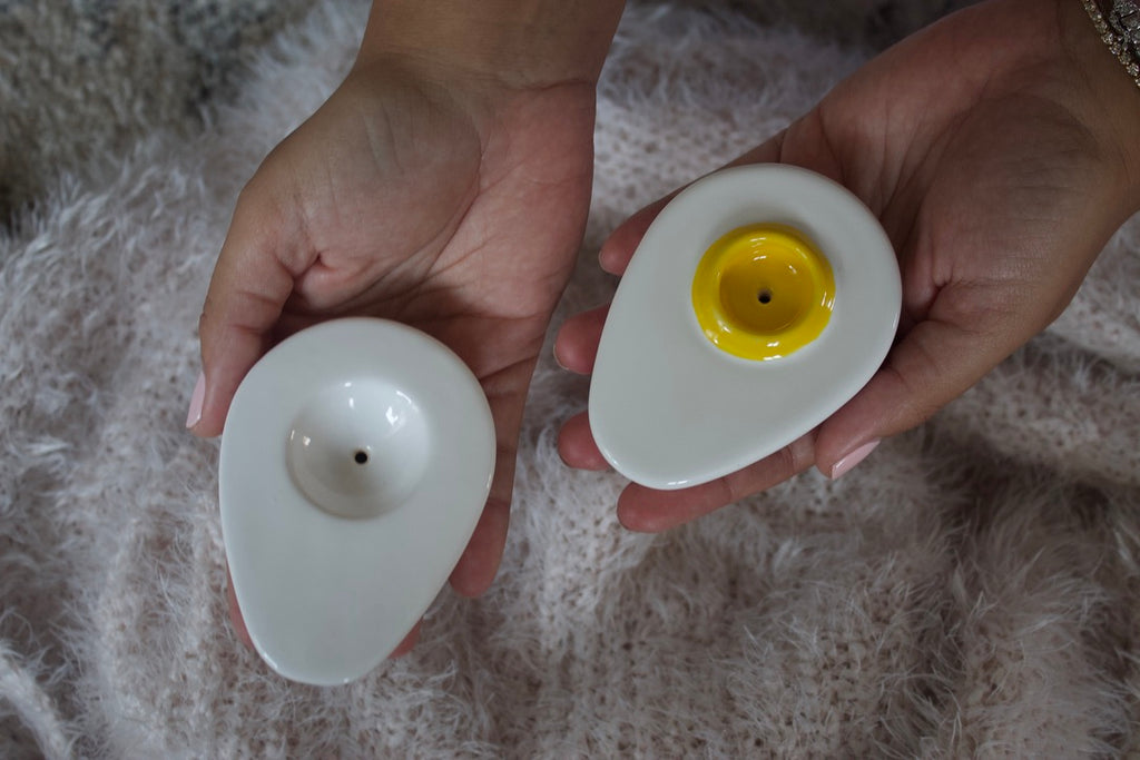 Hands holding both halves of Ceramic Egg