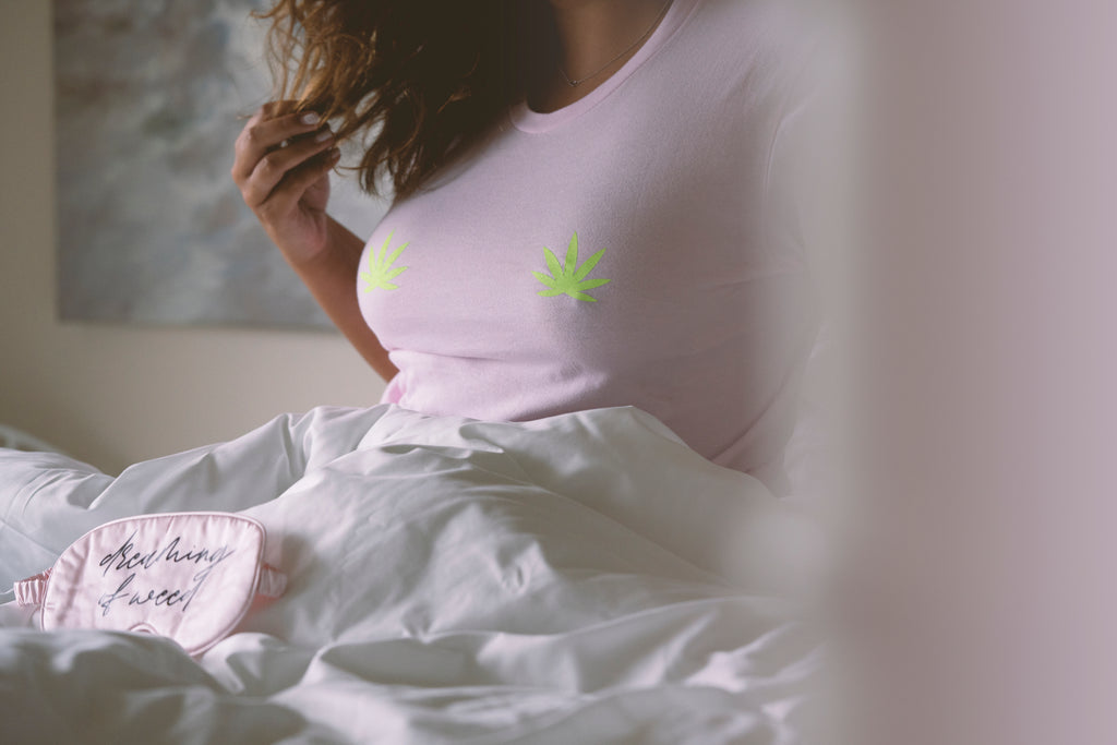 Woman wearing pink leaf shirt in bed