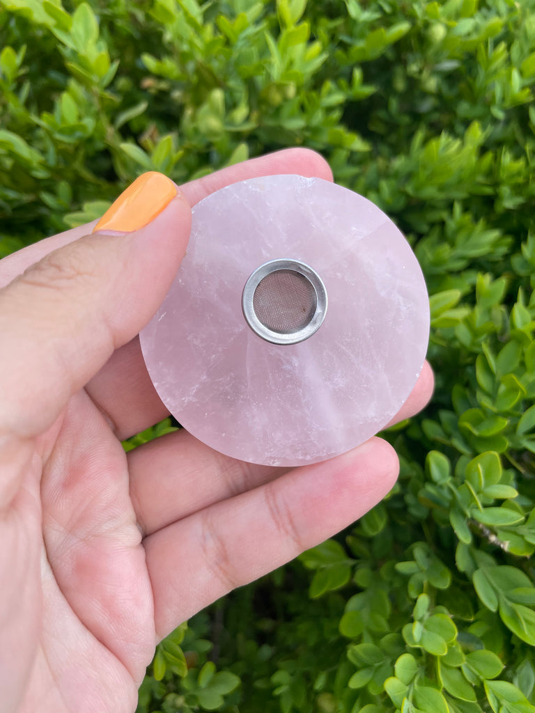 Hand holding Mini Circle Rose Quartz Crystal