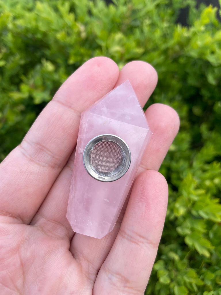 Hand holding Mini Rose Quartz Crystal